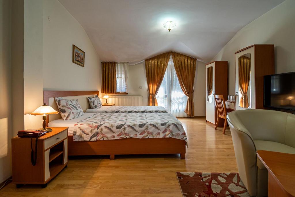 a bedroom with a bed and a tv in it at Primavera 1 Hotel in Pazardzhik