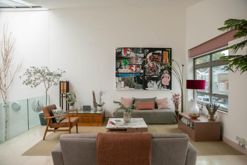a living room with a couch and a table at The Luxury Inn in London
