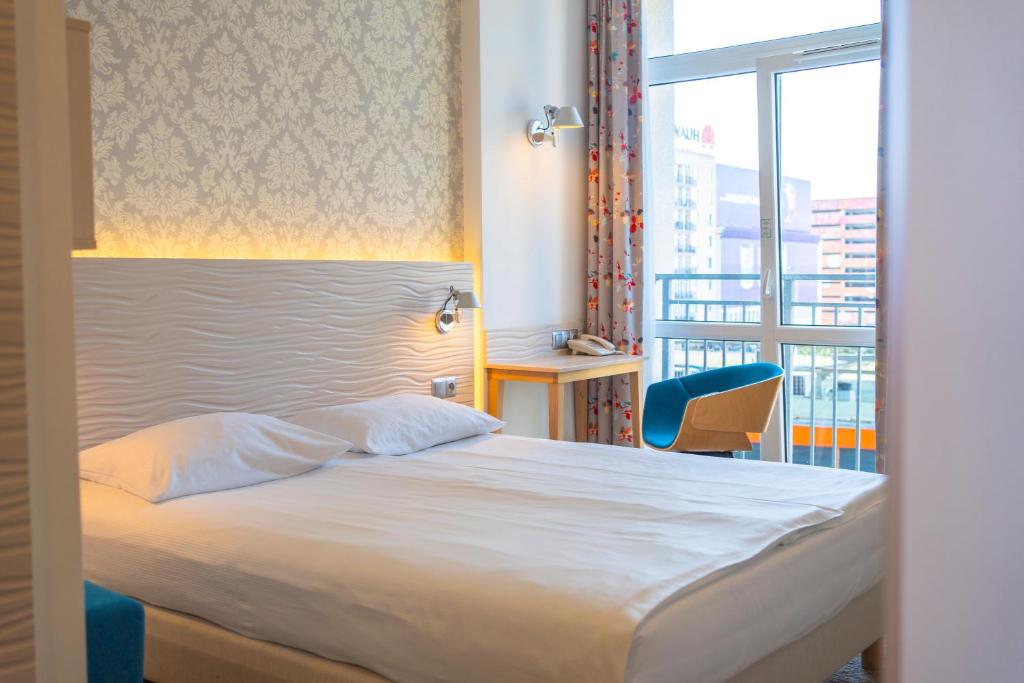 Postel nebo postele na pokoji v ubytování Hotel Metropol