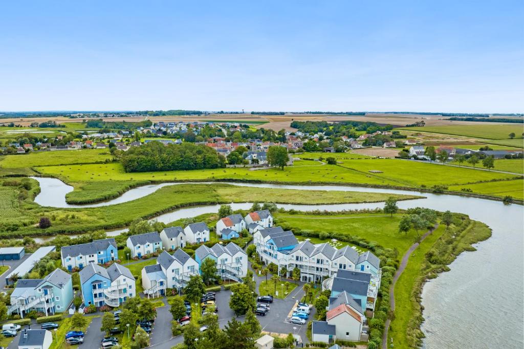 an aerial view of a village with houses and a river at Pierre & Vacances Résidence Le Chant des Oiseaux in Courseulles-sur-Mer