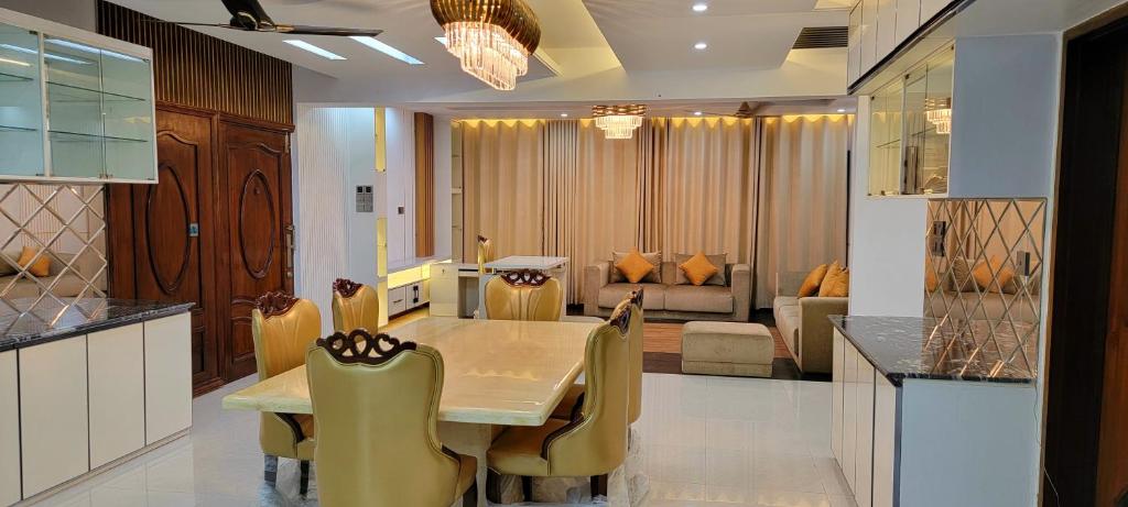 a kitchen and dining room with a table and chairs at Luxurious 3-bhk highly secured & close to airport in Dhaka