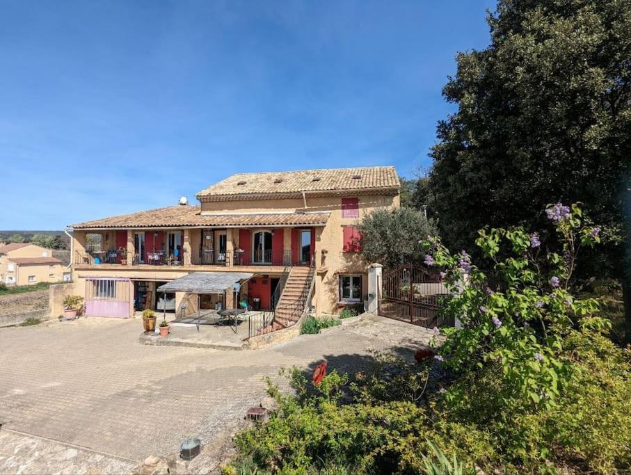 a large house with a large driveway in front of it at Charmant appartement rez de chaussée mas provençal in Sérignan-du-Comtat