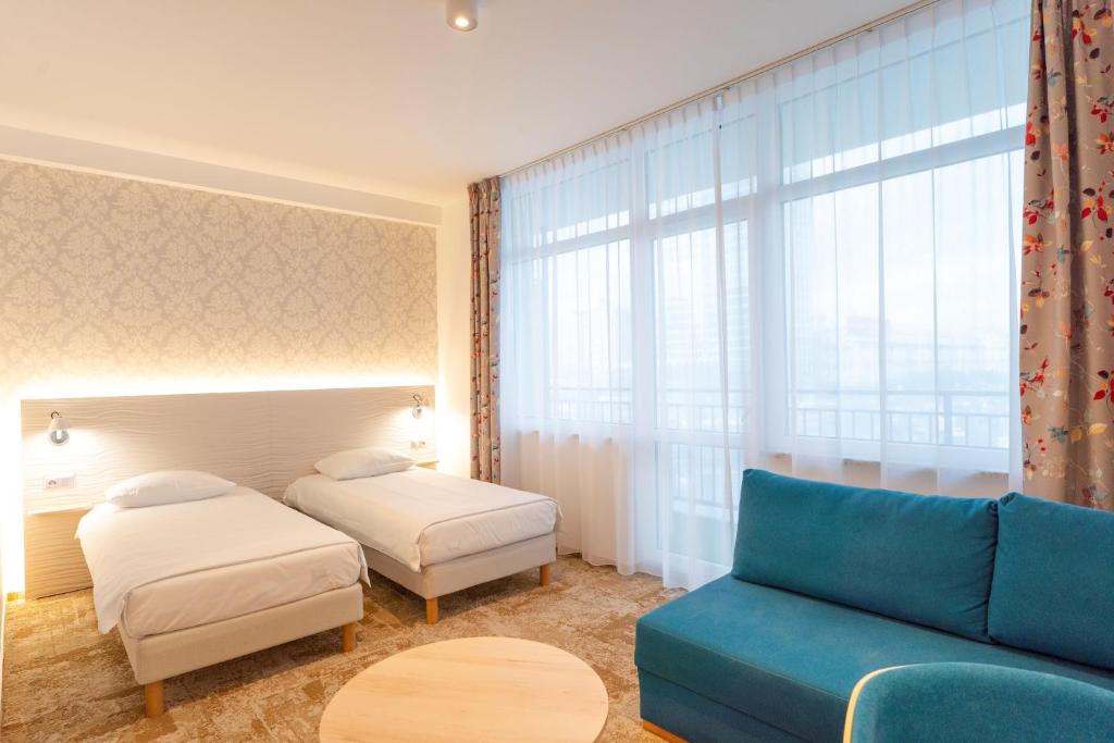 Postel nebo postele na pokoji v ubytování Hotel Metropol