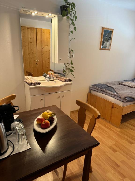 a kitchen with a table with a plate of fruit on it at Haus Edelweiss in Obertraun