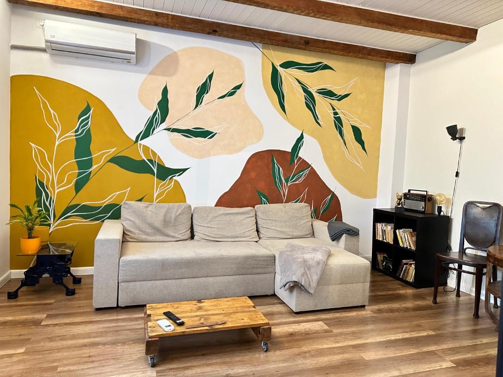 a living room with a couch and a painting on the wall at Interbelic house with courtyard and terrace in Bucharest