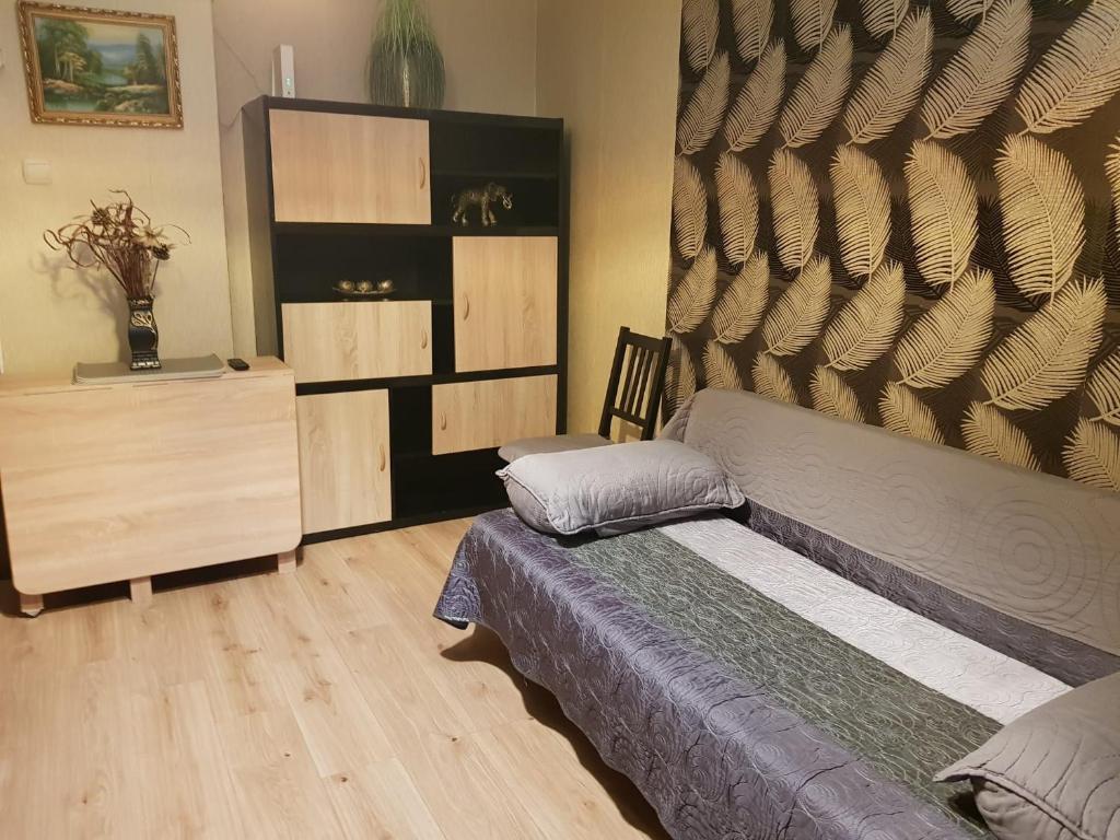 a bedroom with a bed and a dresser at Apartament Silva Busteni in Buşteni