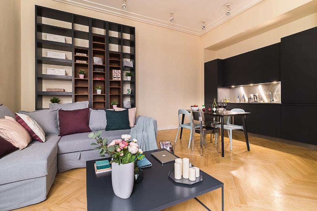a living room with a couch and a table at Rent like home - Hoża 39 in Warsaw