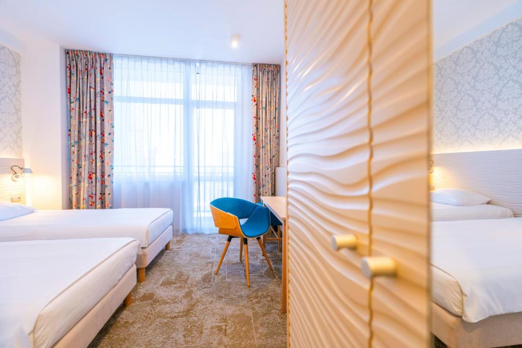 Postel nebo postele na pokoji v ubytování Hotel Metropol