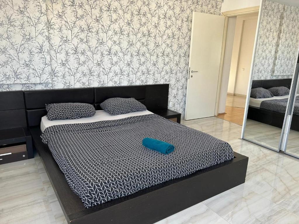 a bedroom with a bed with a blue object on it at Bucharest City Center Apartment in Bucharest