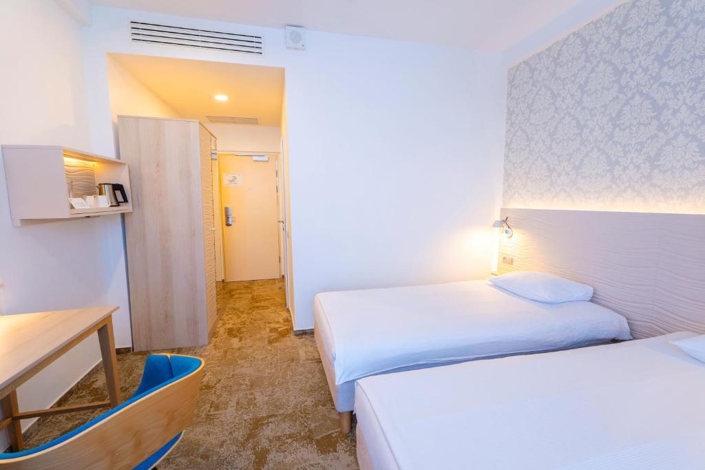 Postel nebo postele na pokoji v ubytování Hotel Metropol