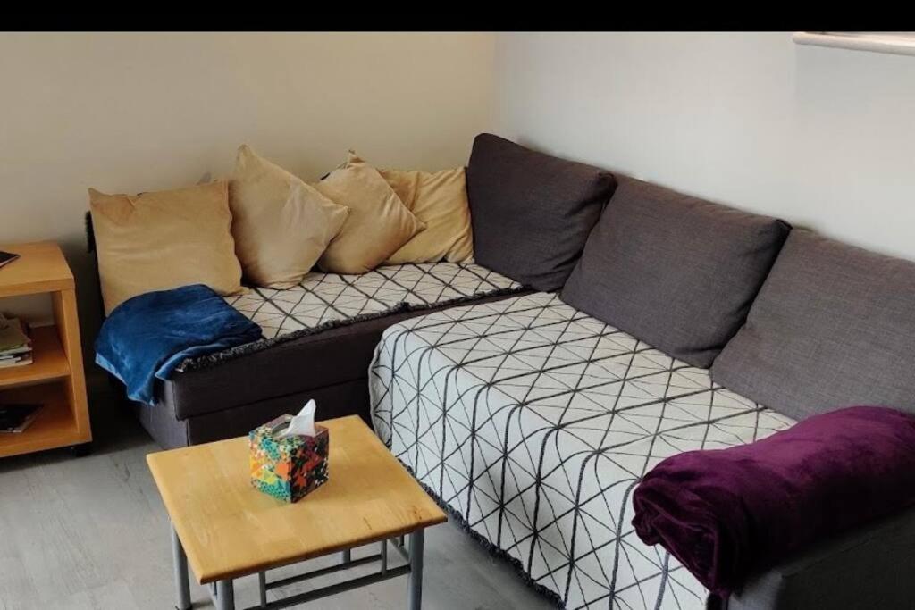a living room with a couch and a table at Lovely 12th floor 2 bed flat in the heart ofLondon in London