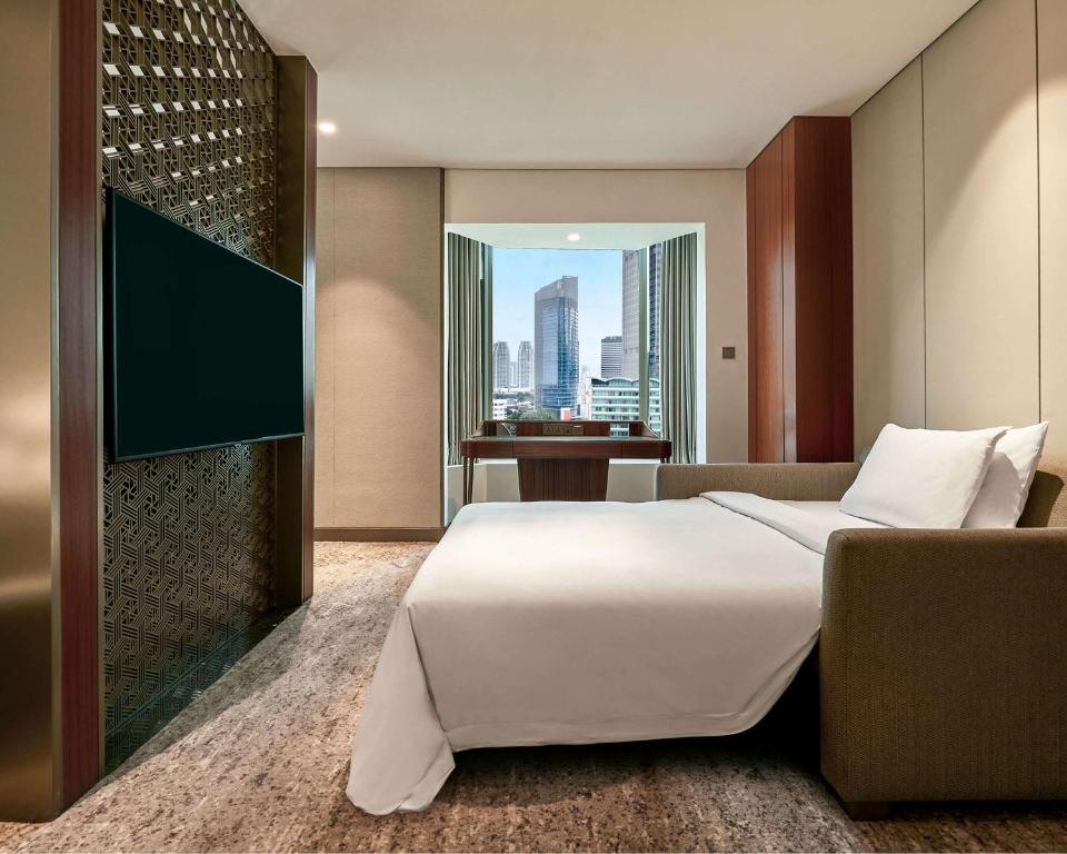 Postel nebo postele na pokoji v ubytování Grand Hyatt Jakarta