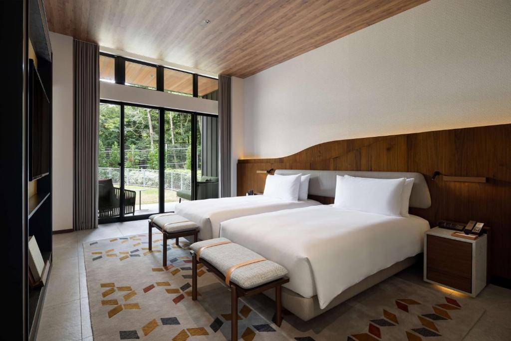 Ένα ή περισσότερα κρεβάτια σε δωμάτιο στο Fuji Speedway Hotel, in The Unbound Collection by Hyatt
