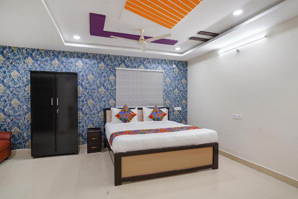 a bedroom with a bed in a room at FabHotel Sri Karthikeya Grand in Hyderabad