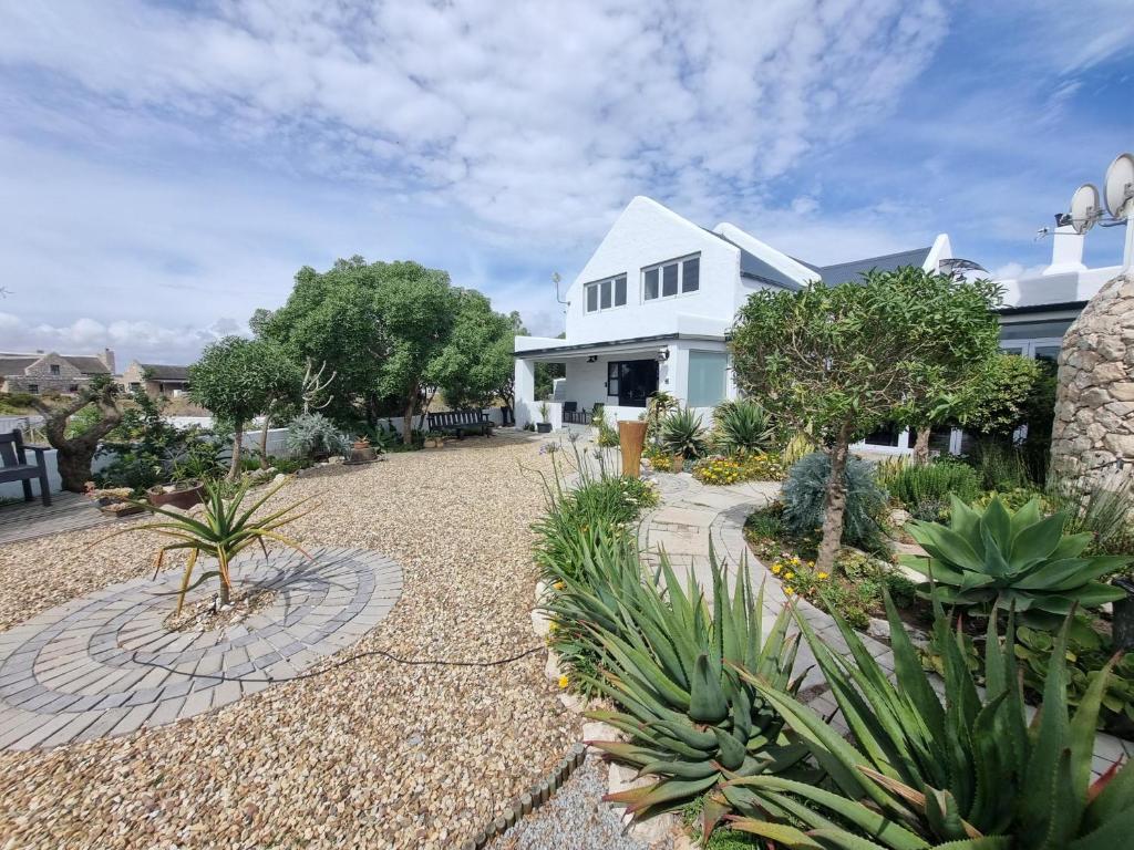 a house with a gravel yard with plants at Manatoka Unit 1 in Jacobs Bay