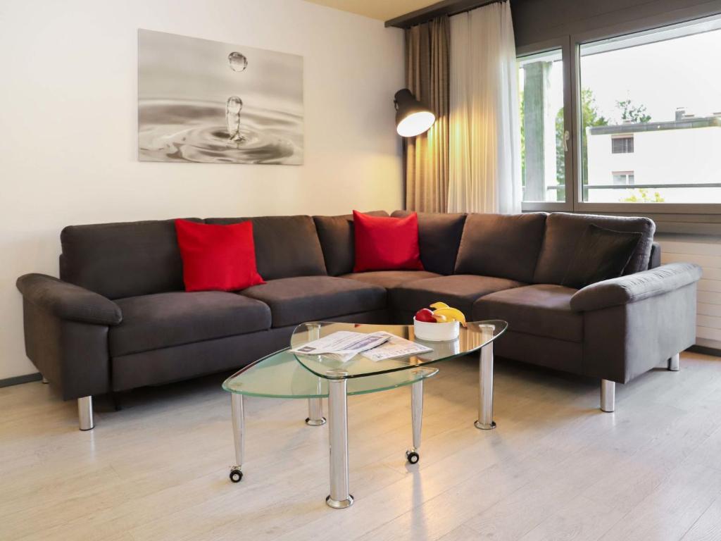 a living room with a couch and a glass table at Apartment Allod Park Haus C 305 by Interhome in Davos