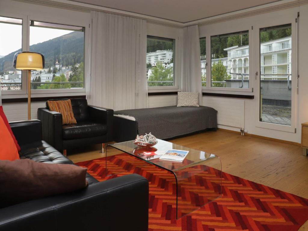 a living room with a couch and a table at Apartment Allod Park Haus C 705 by Interhome in Davos