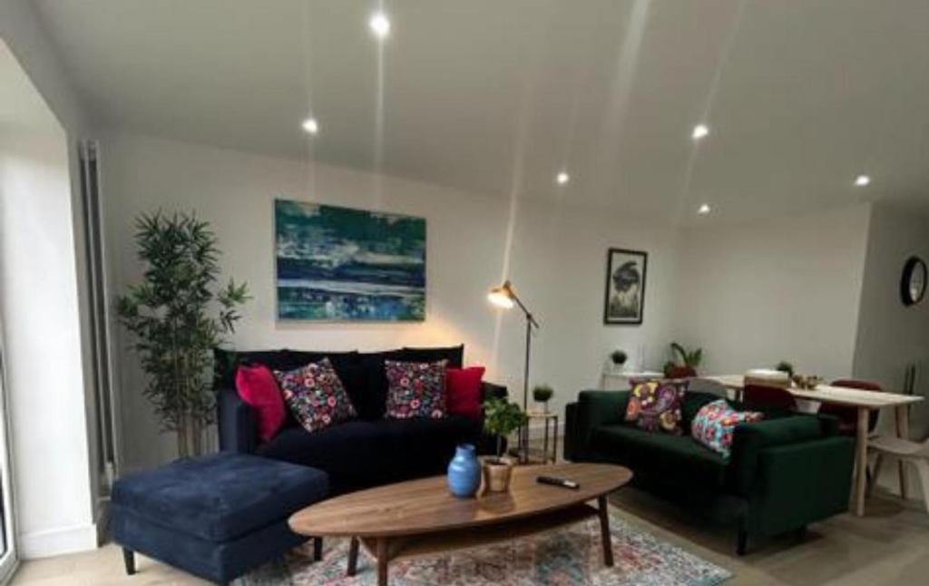 a living room with a couch and a table at London Stunning Three Bedroom House in Mitcham