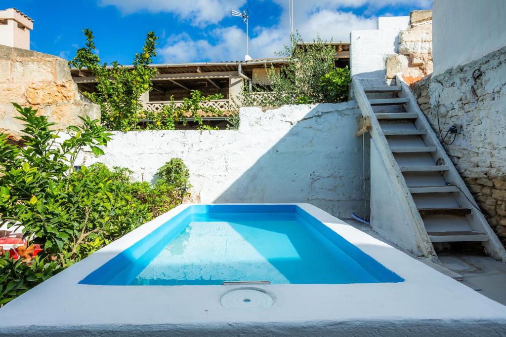 a swimming pool in the backyard of a house at Can Polta in Santa Margalida