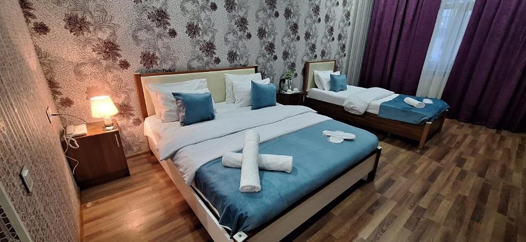 a room with a bed with a cross on it at Nord West Hotel in Baku