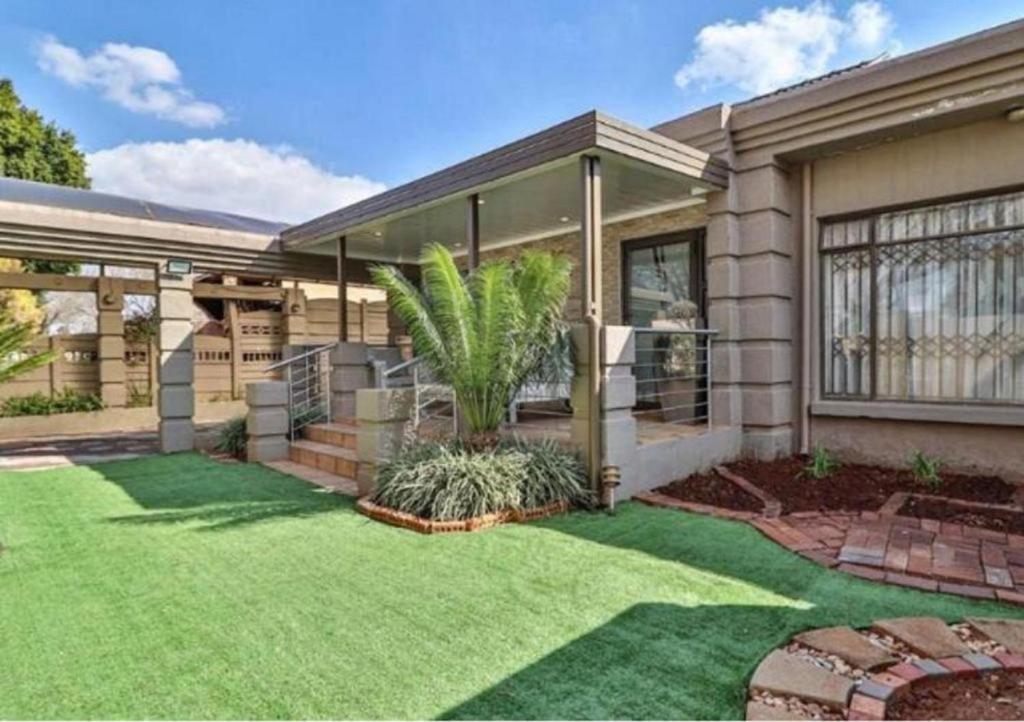 a house with a green lawn in front of it at The Link on Elgin in Kempton Park