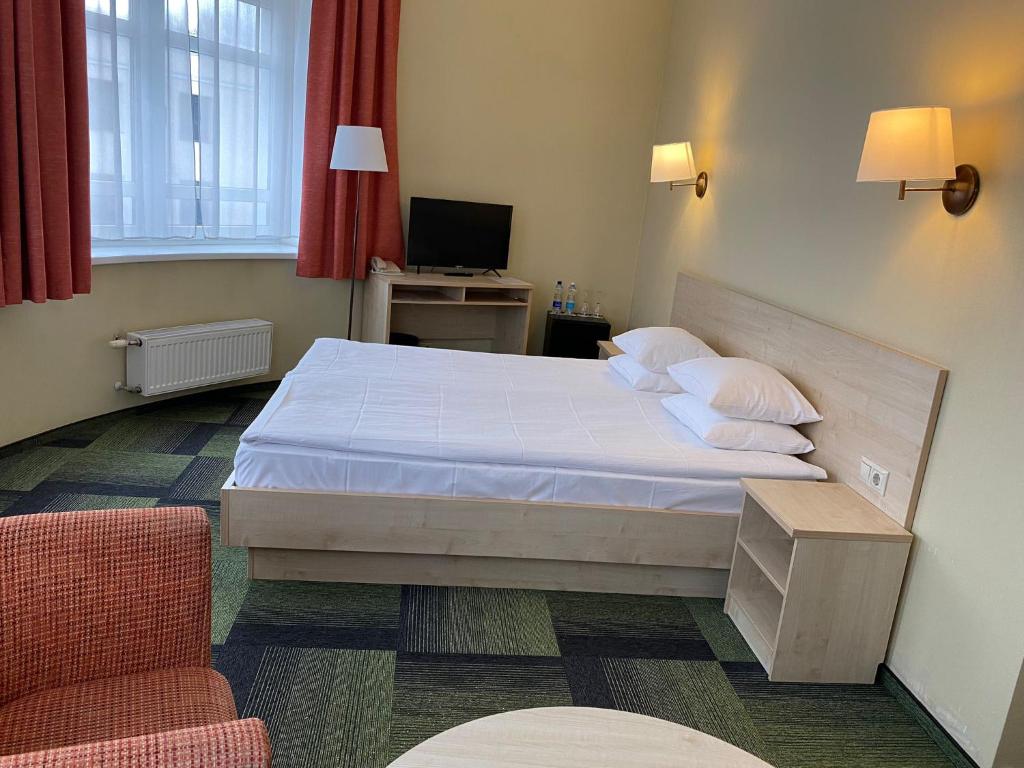 Postel nebo postele na pokoji v ubytování Kolonna Hotel Rēzekne
