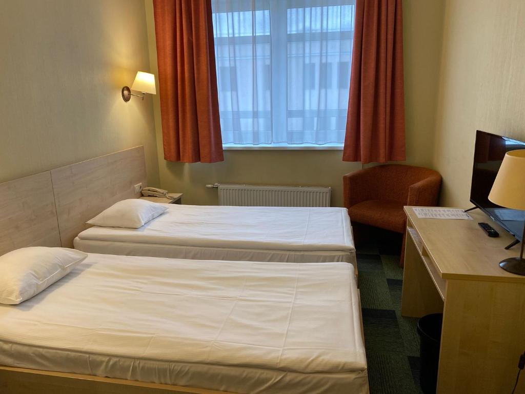 Postel nebo postele na pokoji v ubytování Kolonna Hotel Rēzekne