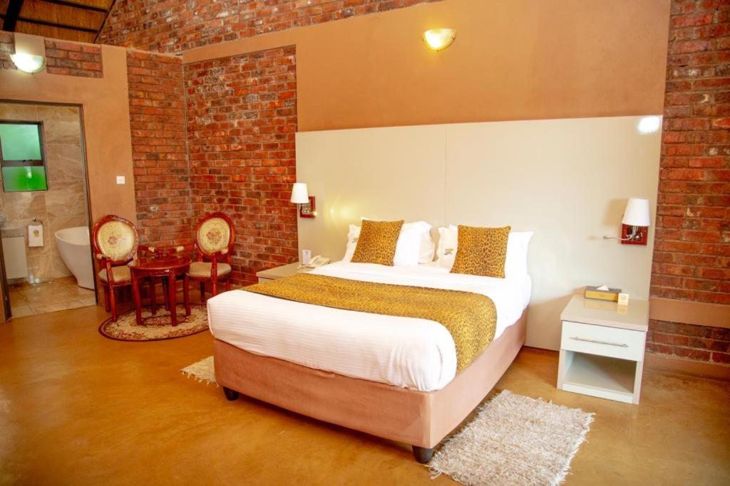 a bedroom with a large bed and a bathroom at Deluxe room on a resort - 2182 in Kingsmead