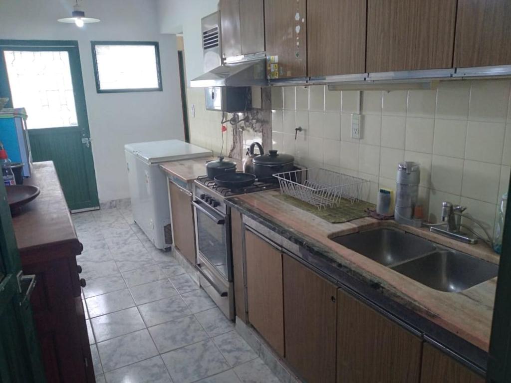 a kitchen with a sink and a stove at La Casa Blanca in Salta