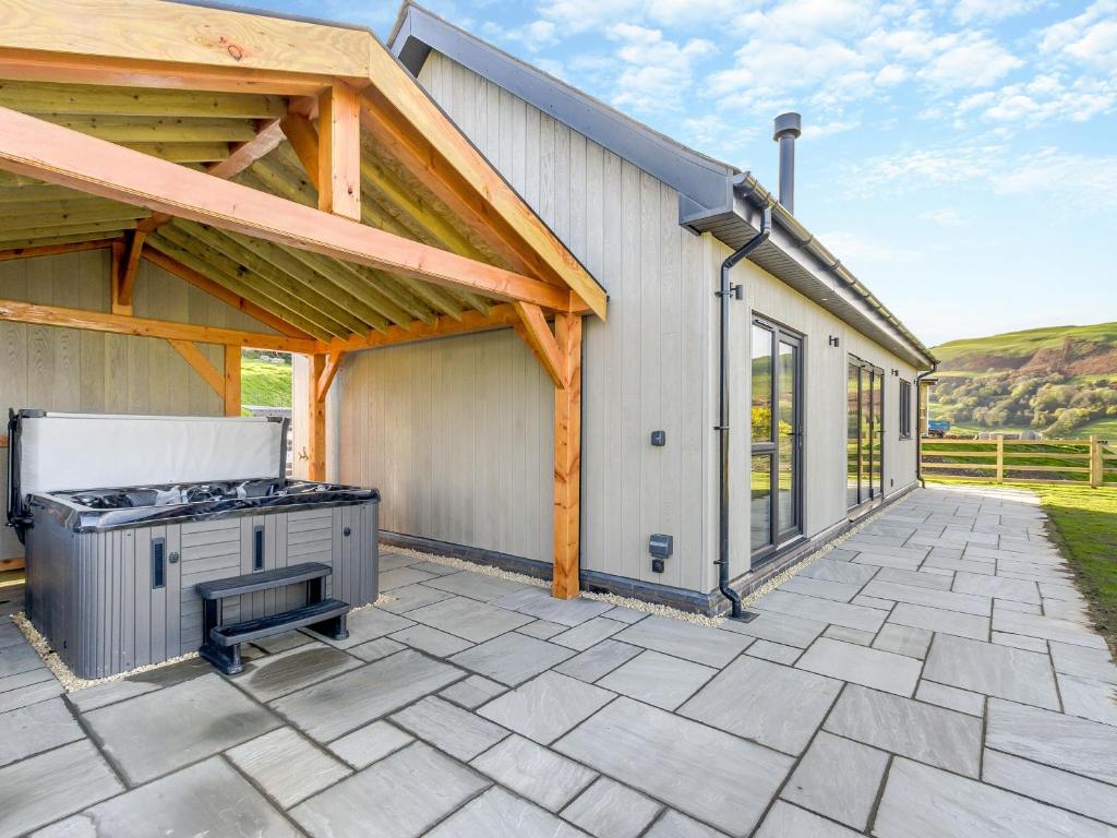 an outdoor patio with a stove and a building at The Warne - Uk45018 in Mochdre