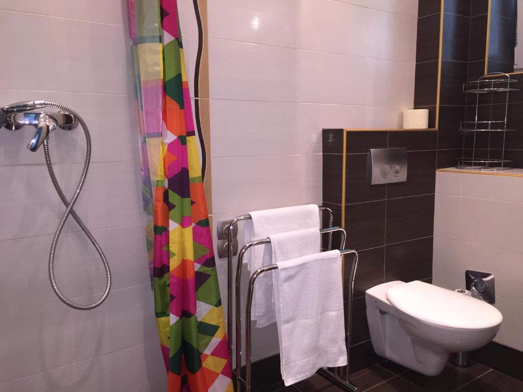 a bathroom with a shower and a sink and a toilet at Marxim Apartments in Budapest