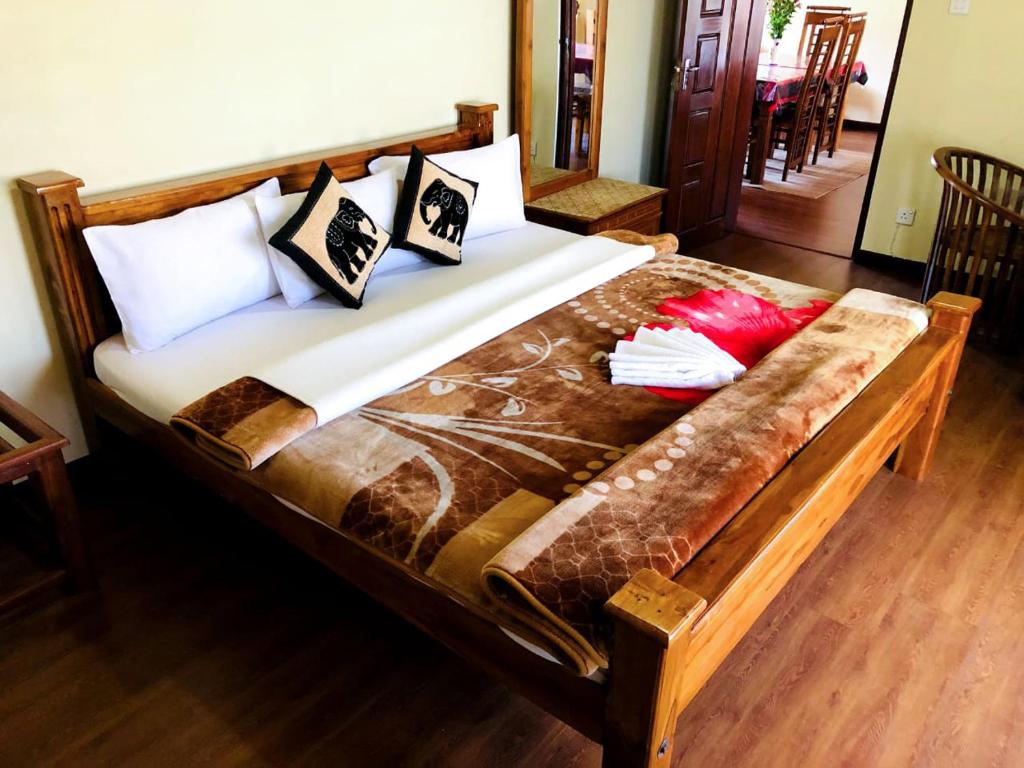 een bed met kussens in een kamer bij Shevyhaws in Nuwara Eliya