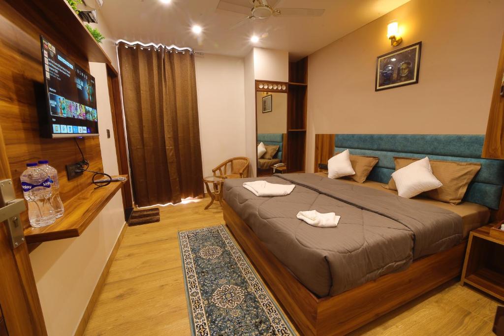 a bedroom with a bed with two towels on it at Hotel Mahadev Rishikesh in Rishīkesh