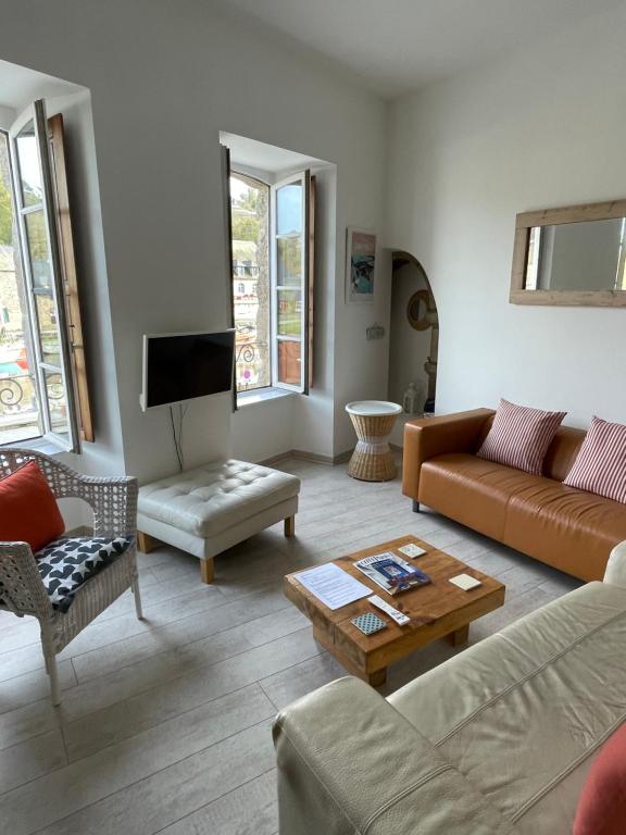 uma sala de estar com um sofá e uma mesa em Appartement au Port em Dinan