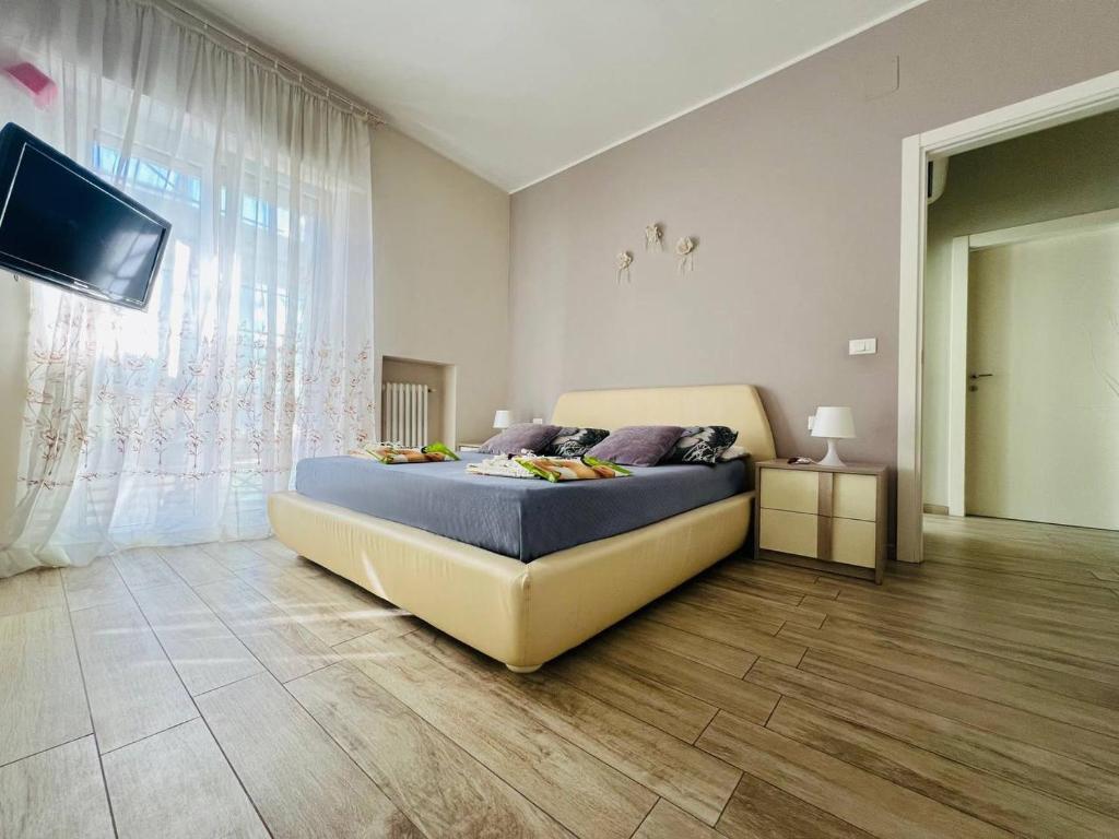 a bedroom with a bed and a flat screen tv at La Dimora degli Artisti in Pescara