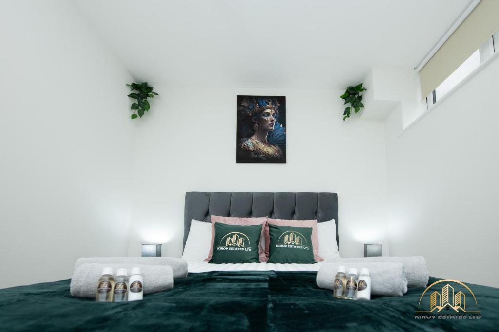 a bedroom with a large bed with green and white pillows at Persephone Apartment - The Goddess of Town in Southampton