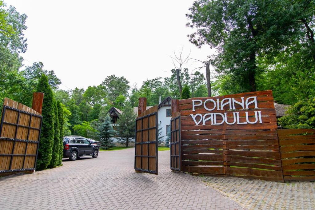 una puerta de madera con un cartel que diga polika pavillon en Vila Poiana Vadului, en Vadul lui Vodă