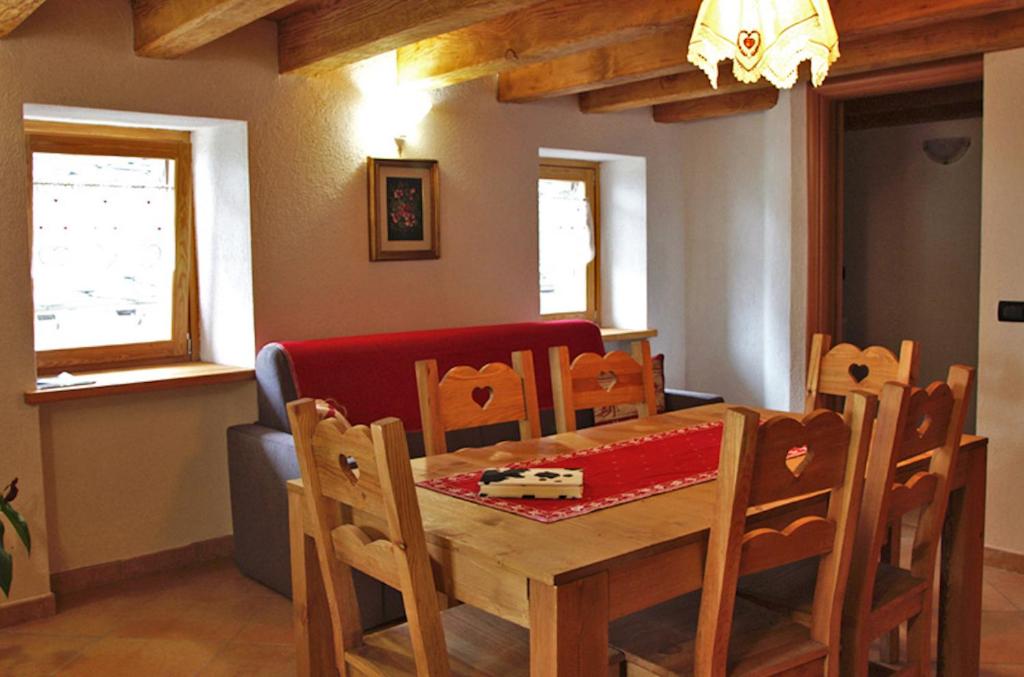 a dining room with a wooden table and chairs at Casa Girod - Il Rustico in Issime