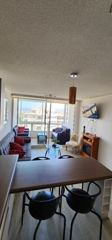 ein Wohnzimmer mit einem großen Tisch und Stühlen in der Unterkunft pacifico 3100 in La Serena