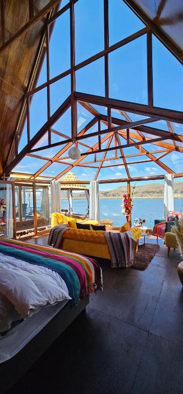 a room with two beds in a building at Glamping Titicaca Perú in Puno