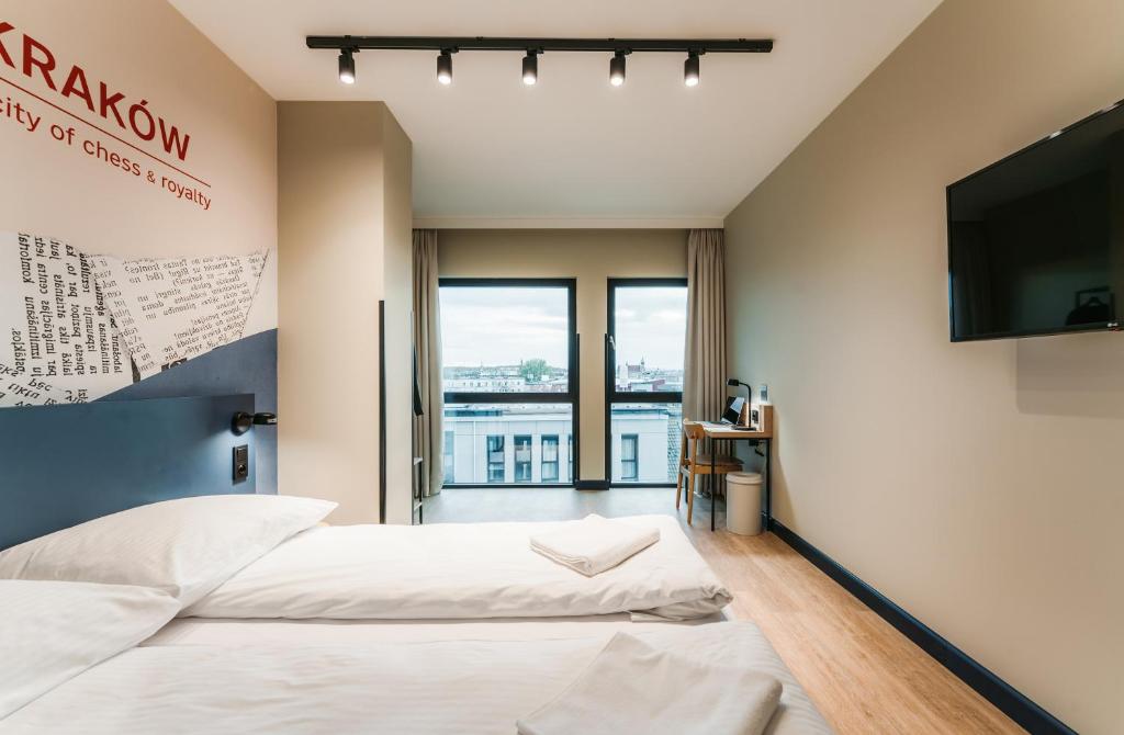 Postel nebo postele na pokoji v ubytování MEININGER Kraków Centrum