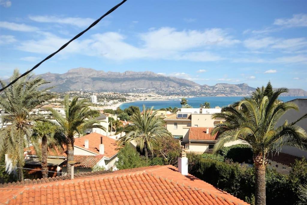 a view of a town with palm trees and water at Yamato Apartment Albir in Albir
