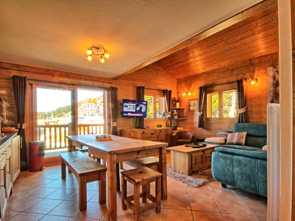 a living room with a table and a couch at Appartement Villard-sur-Doron, 4 pièces, 9 personnes - FR-1-293-89 in Villard-sur-Doron