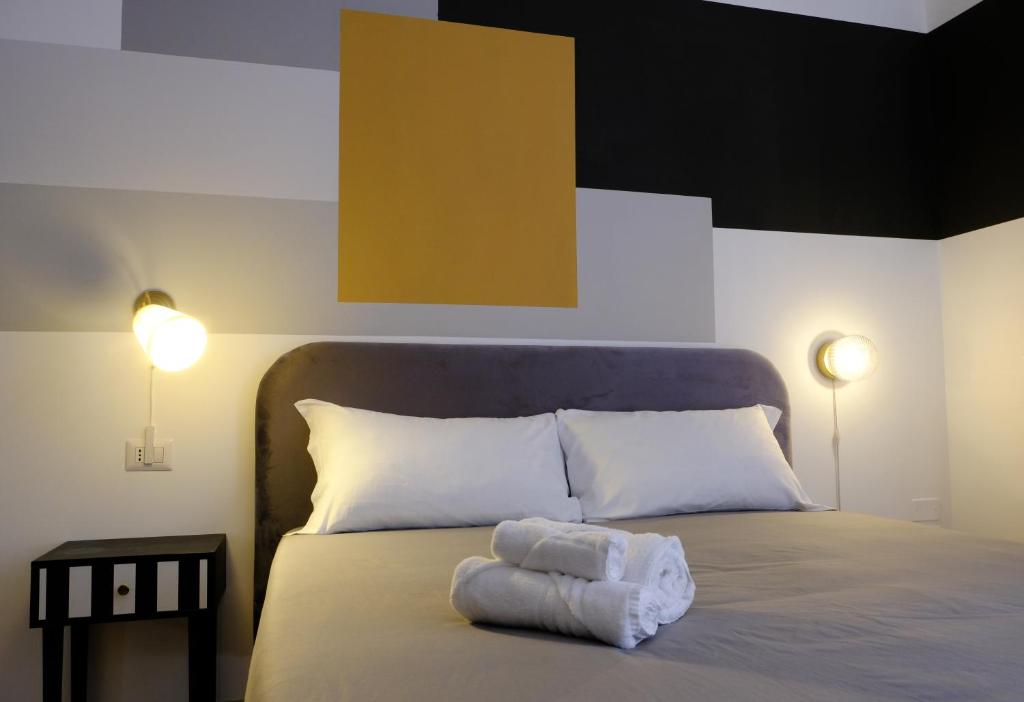 Postel nebo postele na pokoji v ubytování MATTEOTTI ROOMS