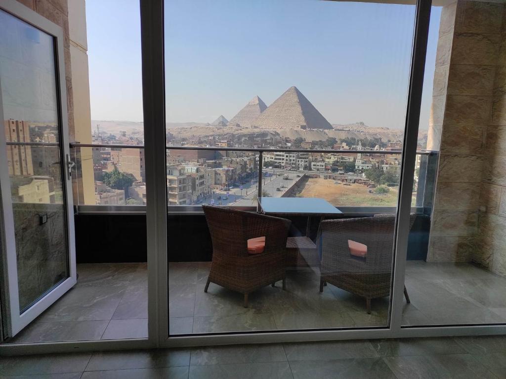 a dining room with a view of the pyramids at pyramids view suite/vista piramidi in Cairo