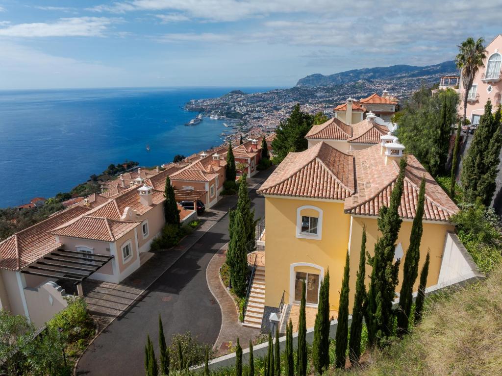 a house with a view of the ocean at Villa Gasparini Palheiro Village by Holiday Rental Madeira in São Gonçalo