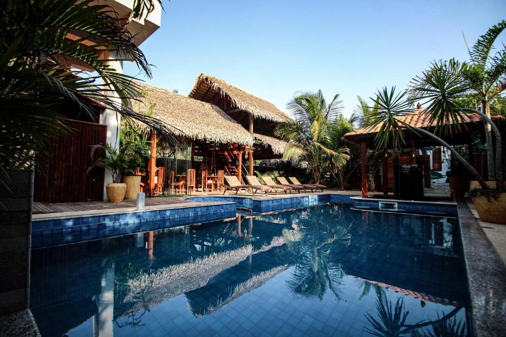 a swimming pool in front of a resort at Villa Éden in Alter do Chao