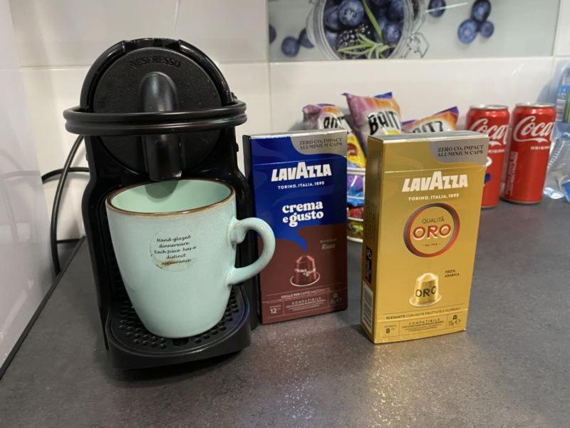 a coffee maker sitting on a counter with a cup of coffee at Apartament ,, Sen i Kawa'' - komfortowy nocleg w sercu aglomeracji in Bytom