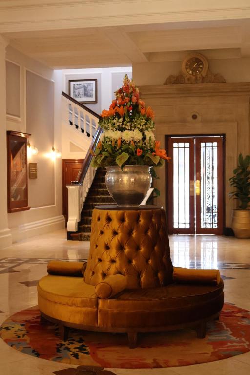 a living room with a couch and a staircase at Private Luxury Residence 906 at TAJ Cape Town in Cape Town