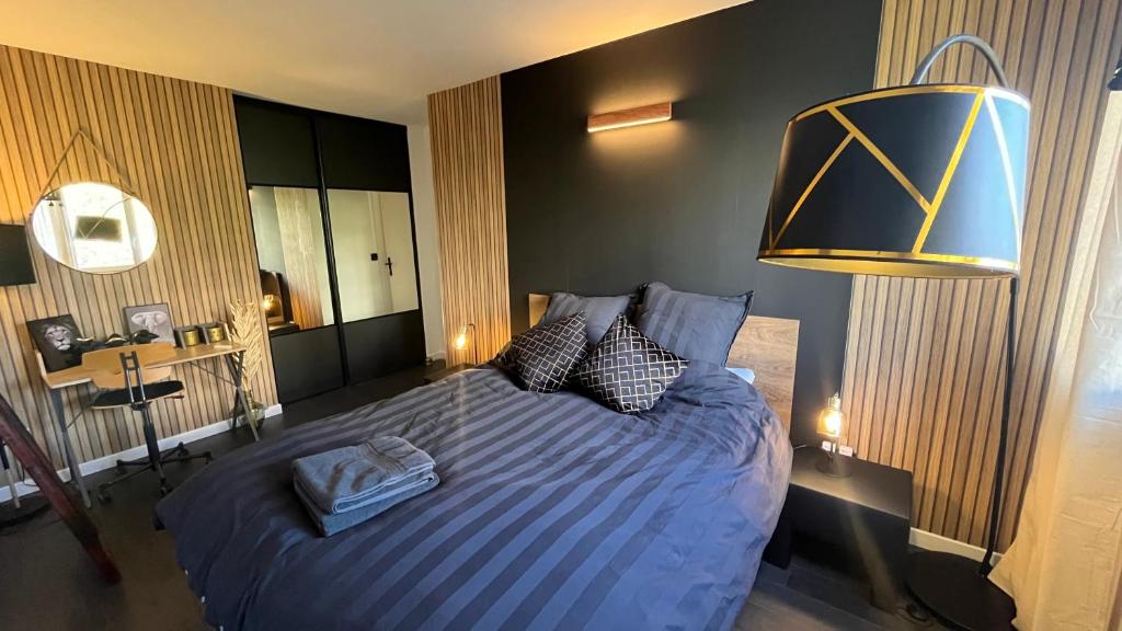 1 dormitorio con 1 cama grande y edredón azul en Appartement cosy - 3 chambres - 700m centre Ecully, en Écully